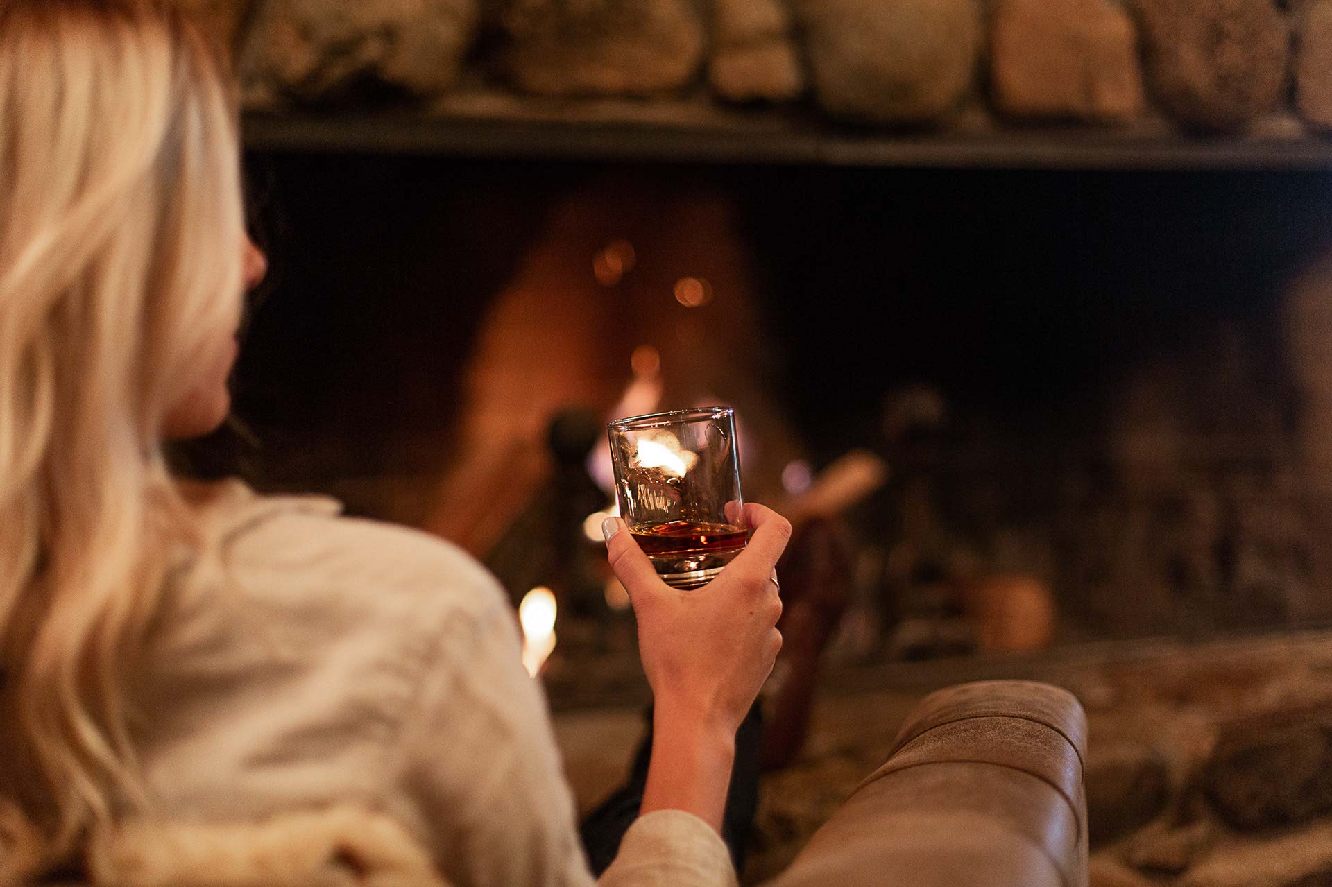 Sipping a whiskey in front of the fireplace in the main lodge
