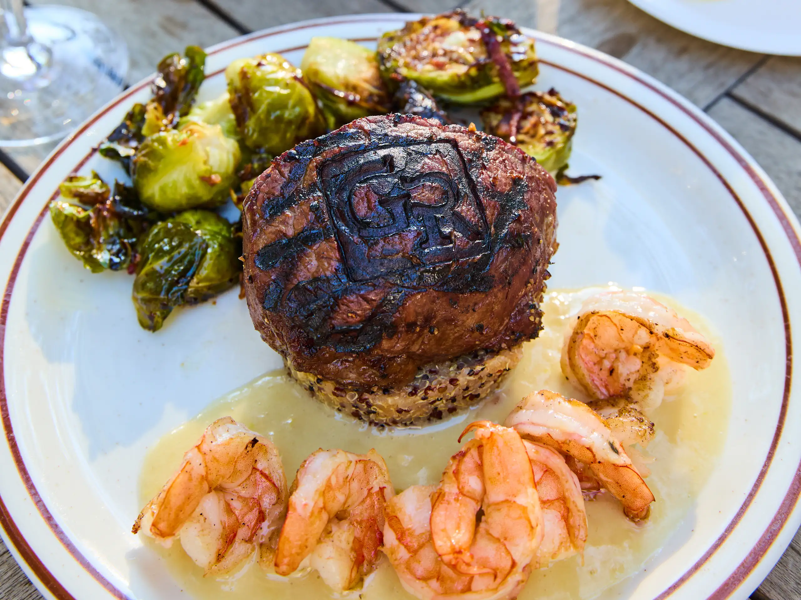 Grilled steak and shrimp dinner served with roasted Brussels sprouts at Greenhorn Ranch
