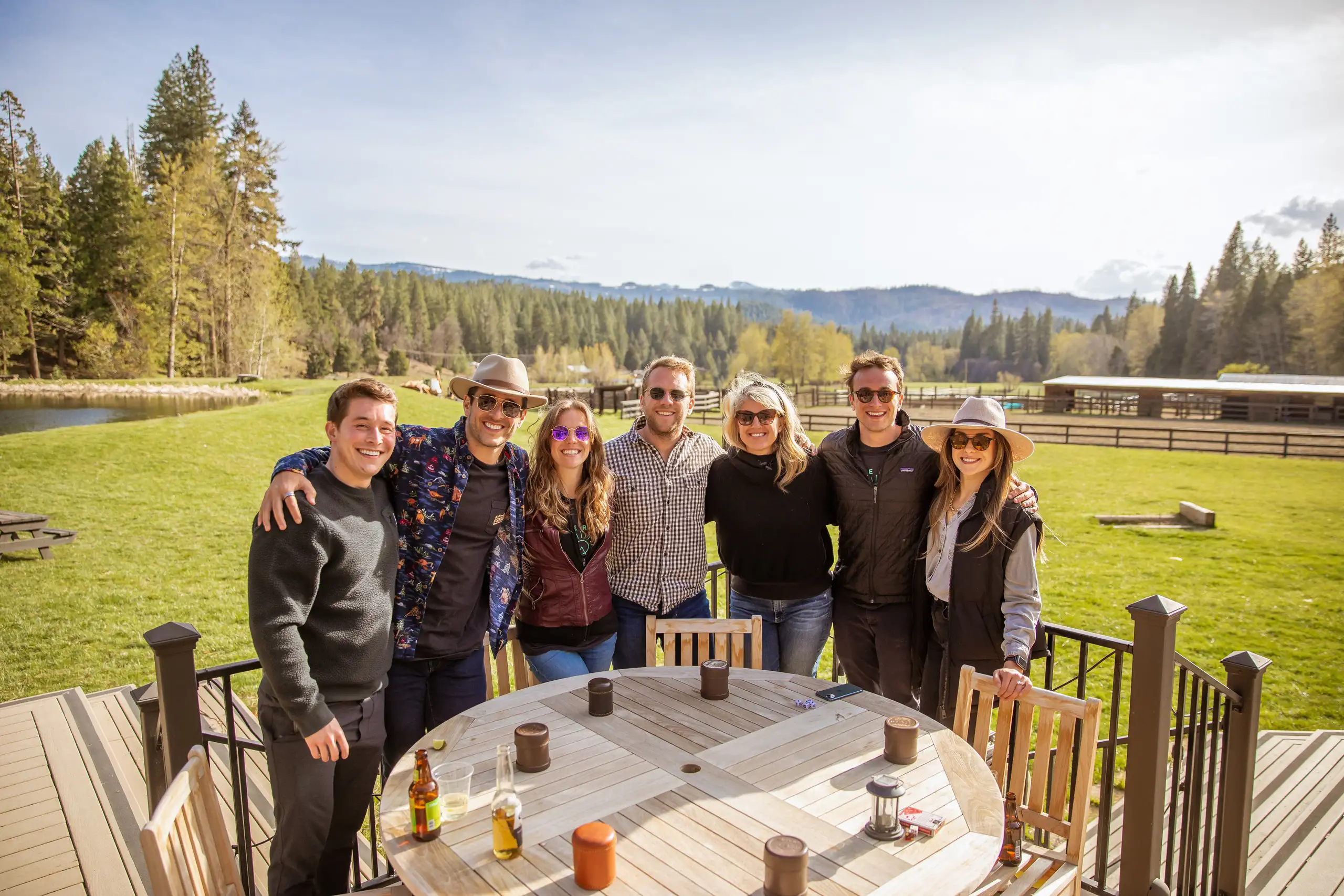 small-raise-group Friends enjoying drinks and mountain views on the Greenhorn Ranch patio