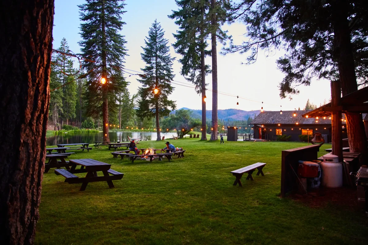 Guests relaxing on the lawn near the saloon and picnic area at Greenhorn Ranch
