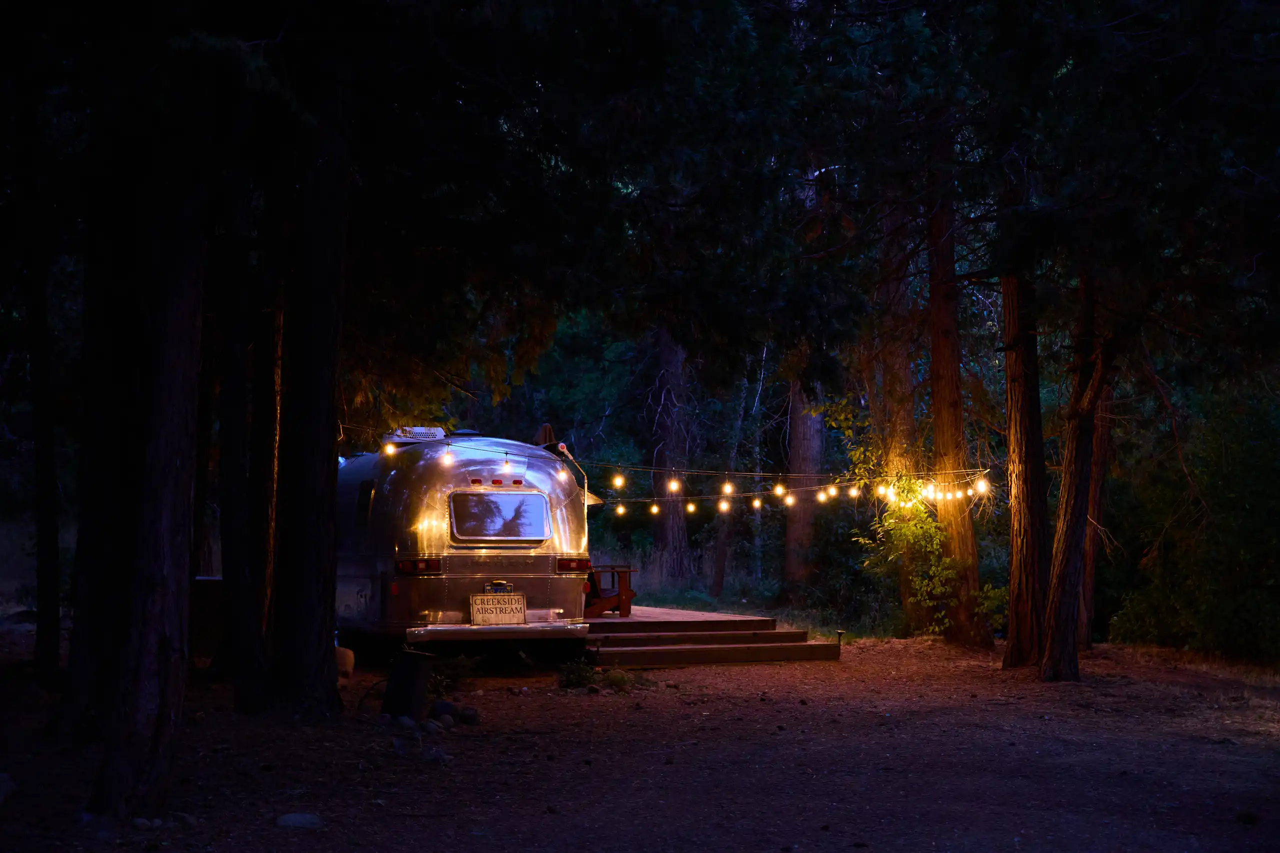 greenhorn-ranch-property-07 Vintage Airstream accommodations illuminated beneath the pine trees at Greenhorn Ranch